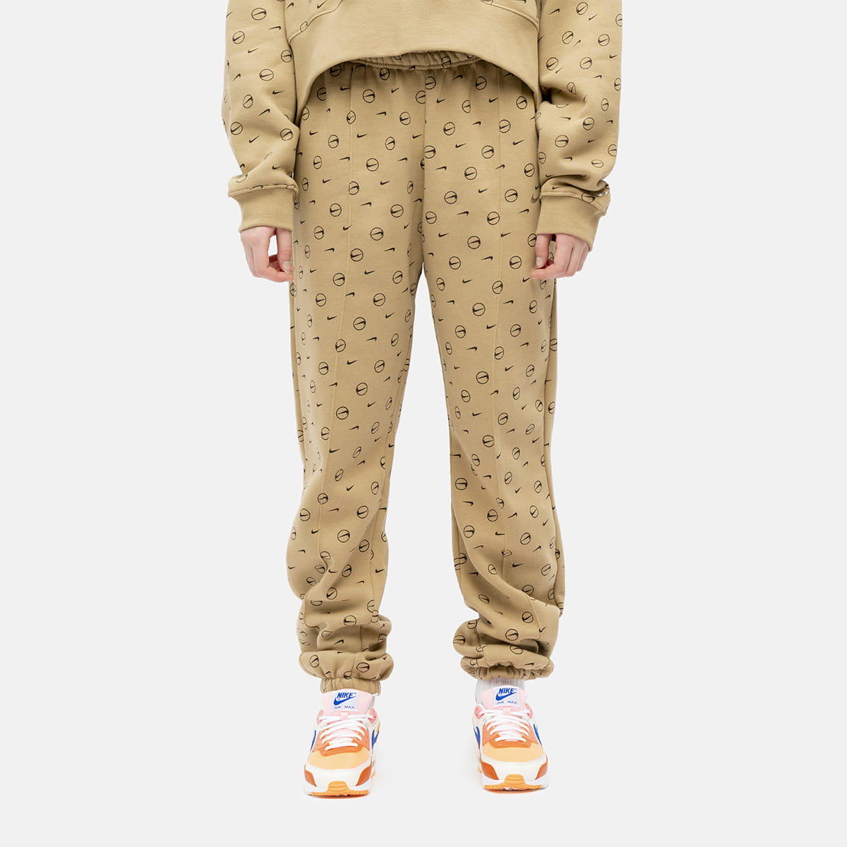 nike all over logo print joggers in camel